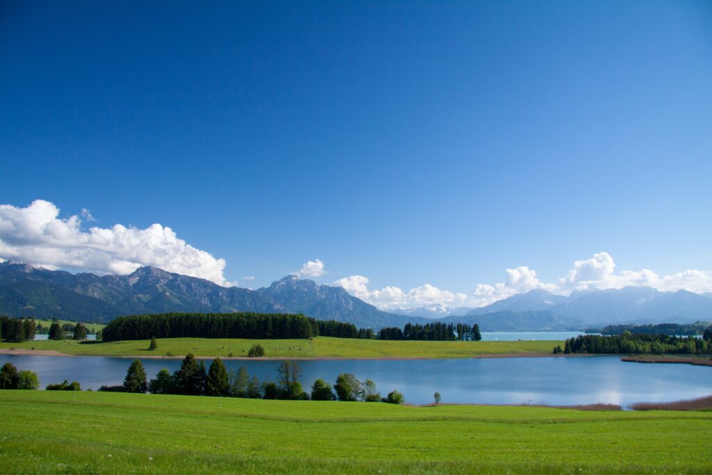 Im Vordergrund der Illasbergsee, im Hintergrund der Forggensee